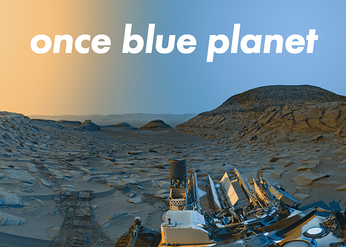 A rocky martian landscape with hills in the distance. Across the sky is an orange colour, fading to blue. At the bottom center of the image are the various tools and scientific instruments of a martian rover. White text in the sky reads 'once blue planet'.